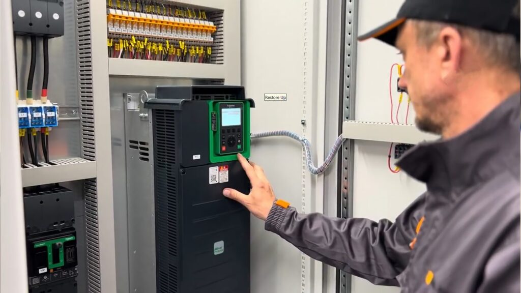 Industrial maintenance engineer checking plc