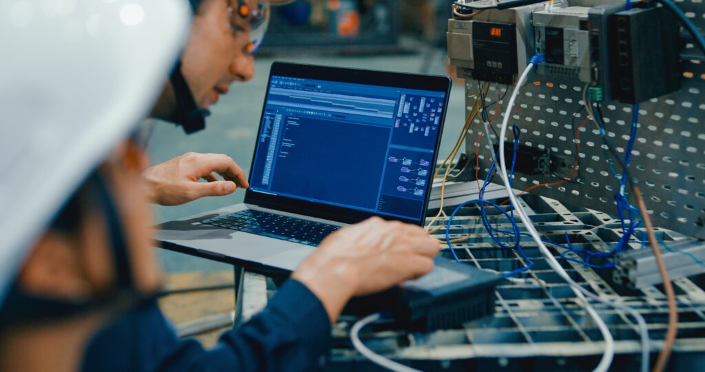 ASA-Projekt engineer doing PLC programming on industrial equipment